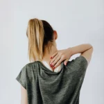 woman holding neck - chiropractic care for auto accident injury