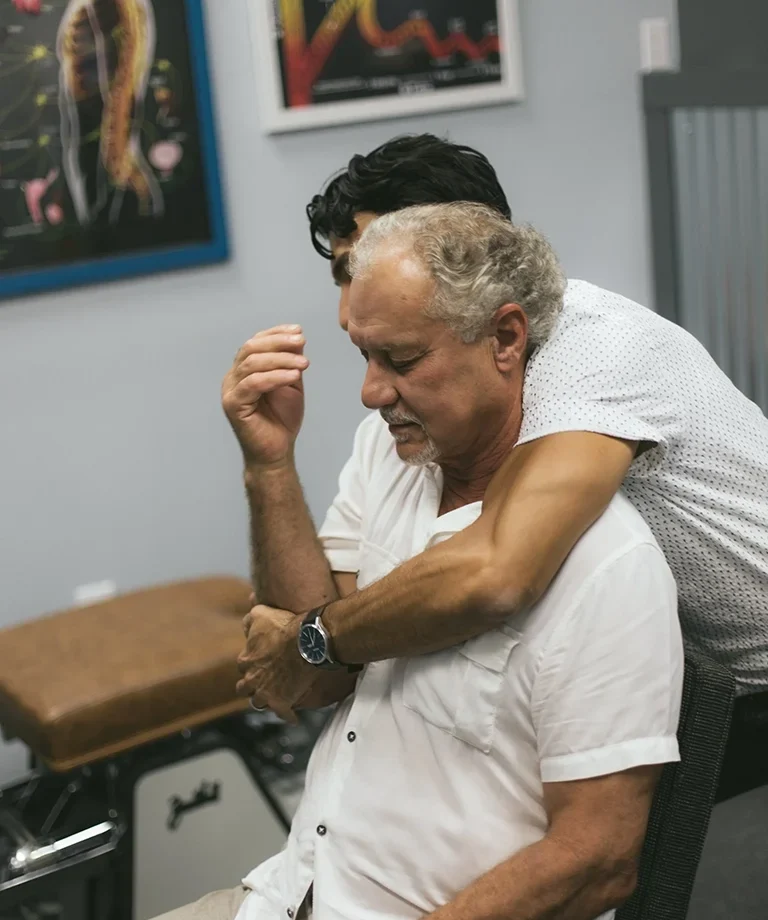 man receiving spinal adjustment for auto injury chiropractor sarasota