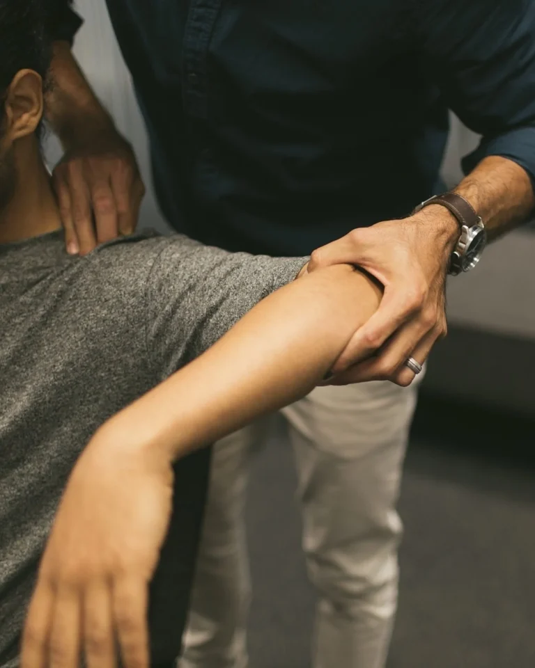 chiropractor adjusting patient's elbow - Chiropractic care for extremities