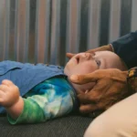 baby receiving chiropractic adjustment -pediatric spinal care