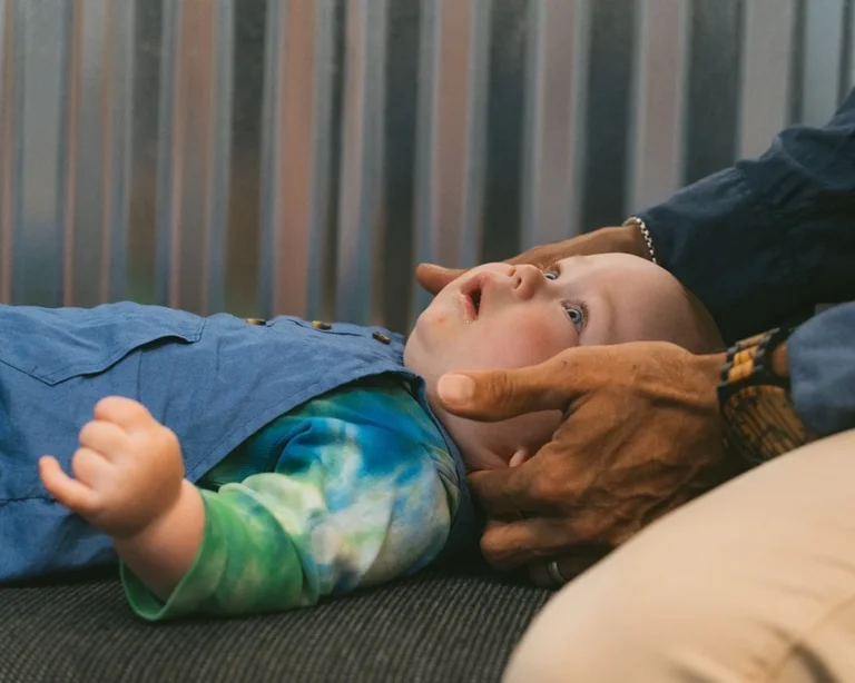 baby receiving chiropractic adjustment -pediatric spinal care