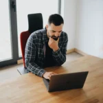 man working on computer- tech neck - chiropractic care for posture and performance