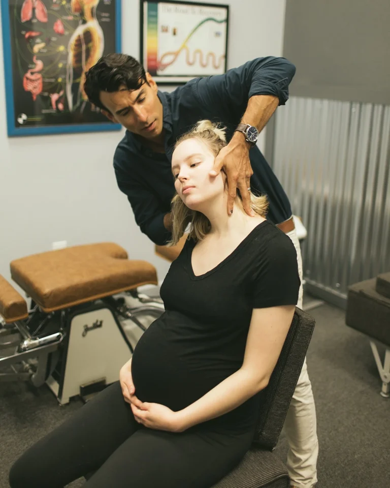 pregnant woman receiving neck and spinal adjustment- chiropractic care for pregnancy comfort