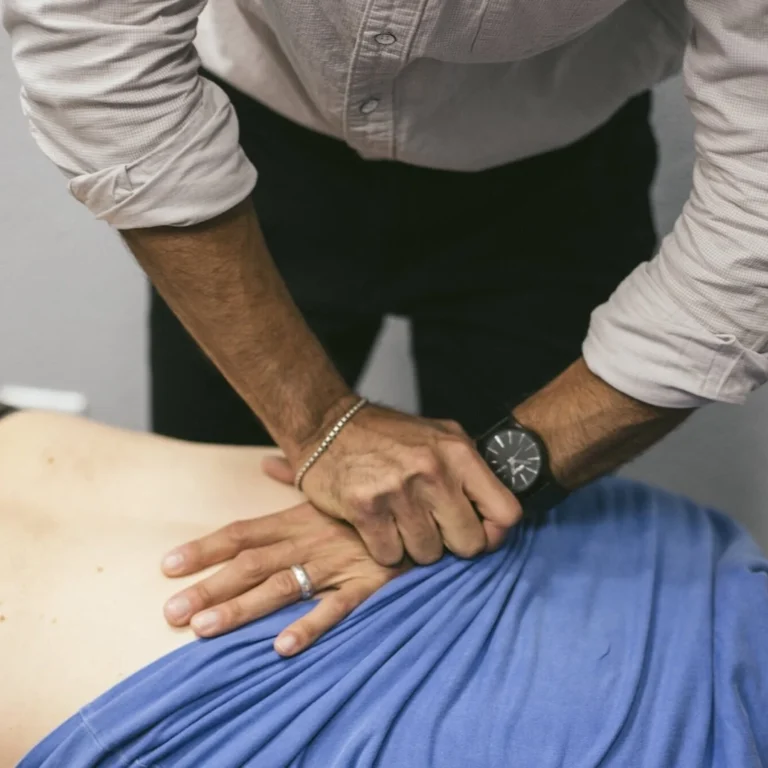 Chiropractor doing spinal adjustment for back pain