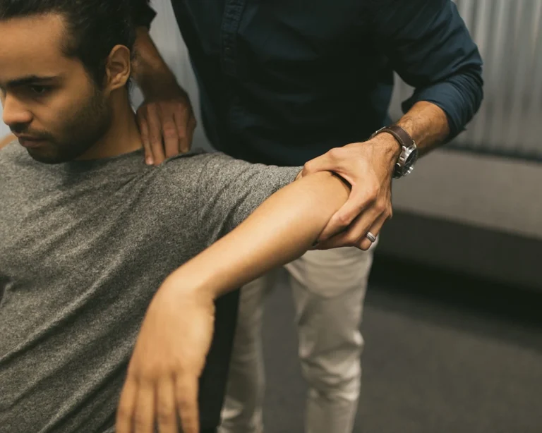 Dr Fano examining patient's elbow - shoulder and arm pain chiropractor sarasota