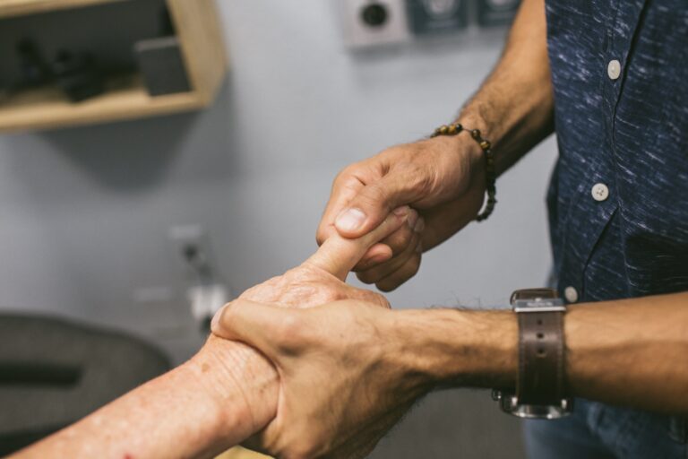 Gonstead chiropractor in Sarasota performing a specific extremity adjustment for trigger finger.